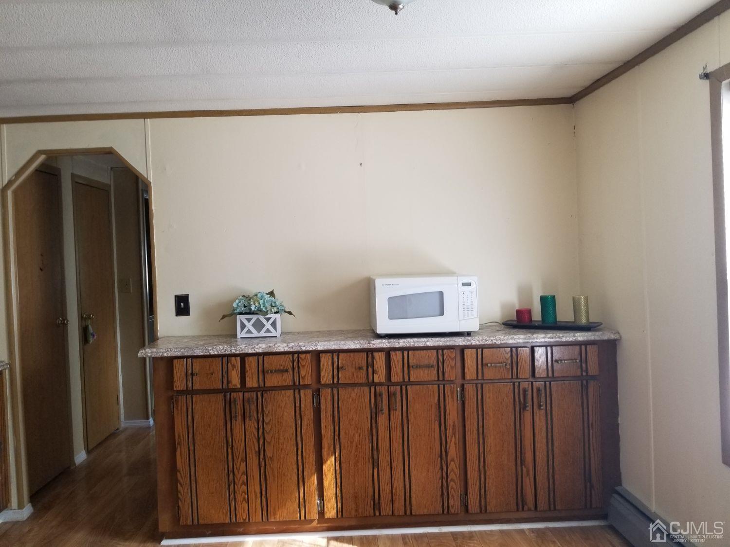 39 Emerson Road North Brunswick, NJ 08902 - Photo 13 of 23 a bedroom with a bed and wooden floor