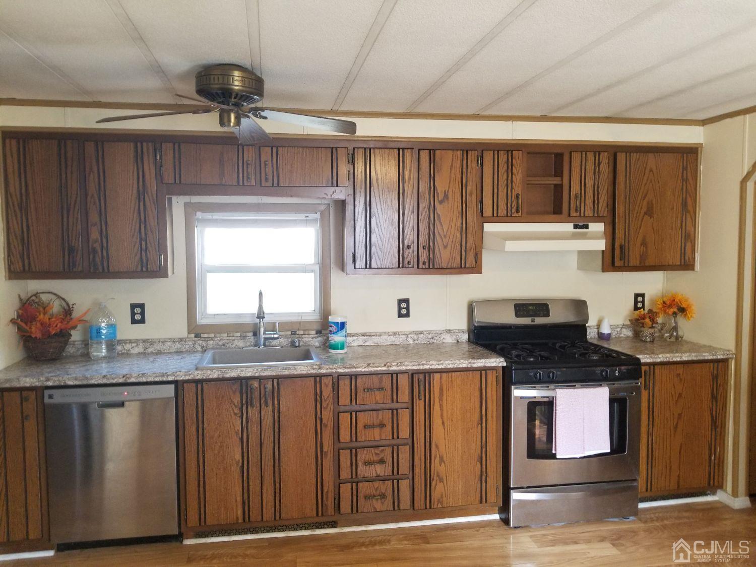 39 Emerson Road North Brunswick, NJ 08902 - Photo 14 of 23 a kitchen with granite countertop a sink cabinets and window