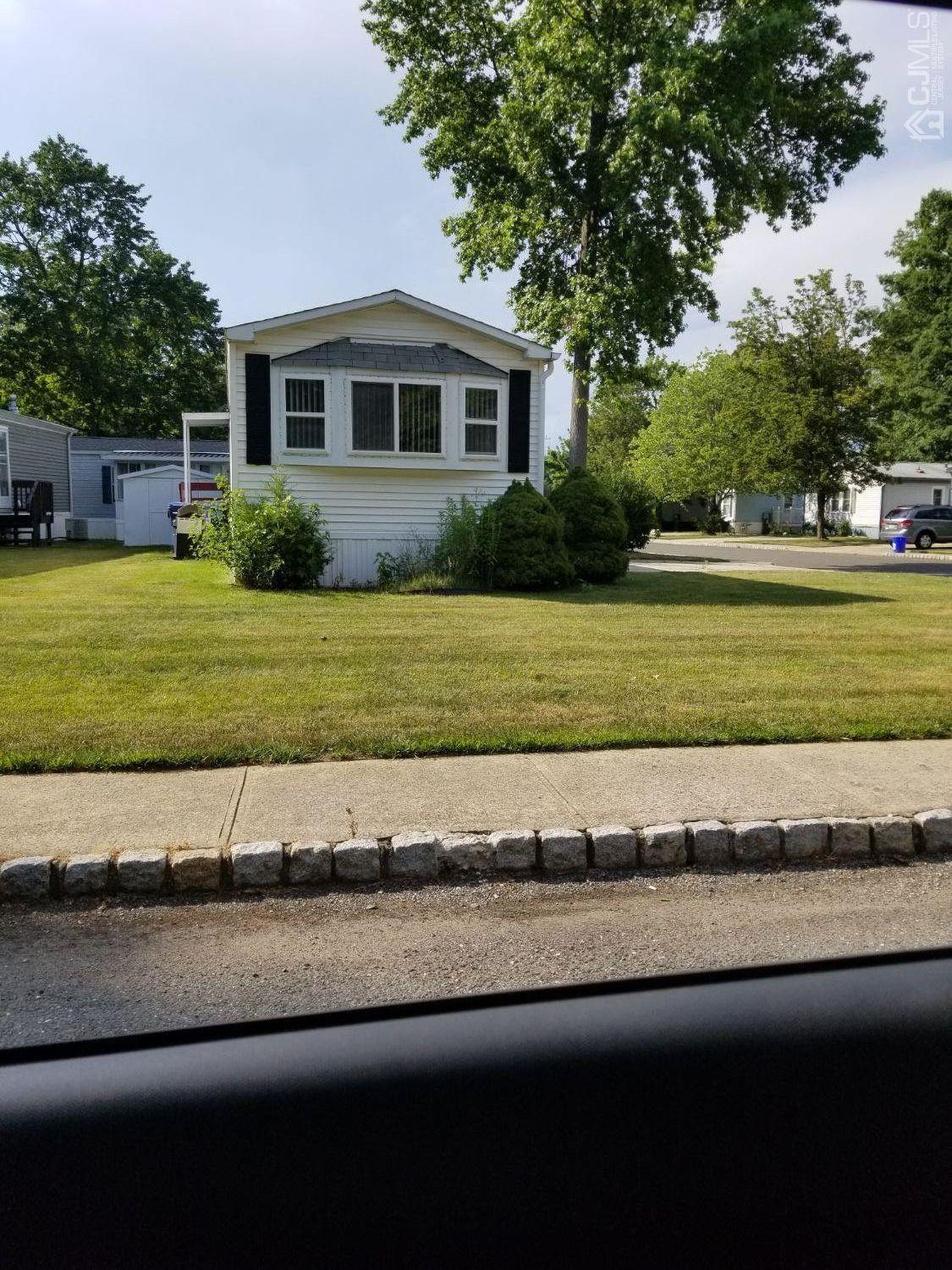 39 Emerson Road North Brunswick, NJ 08902 - Photo 22 of 23 a view of a house with a yard and a large tree