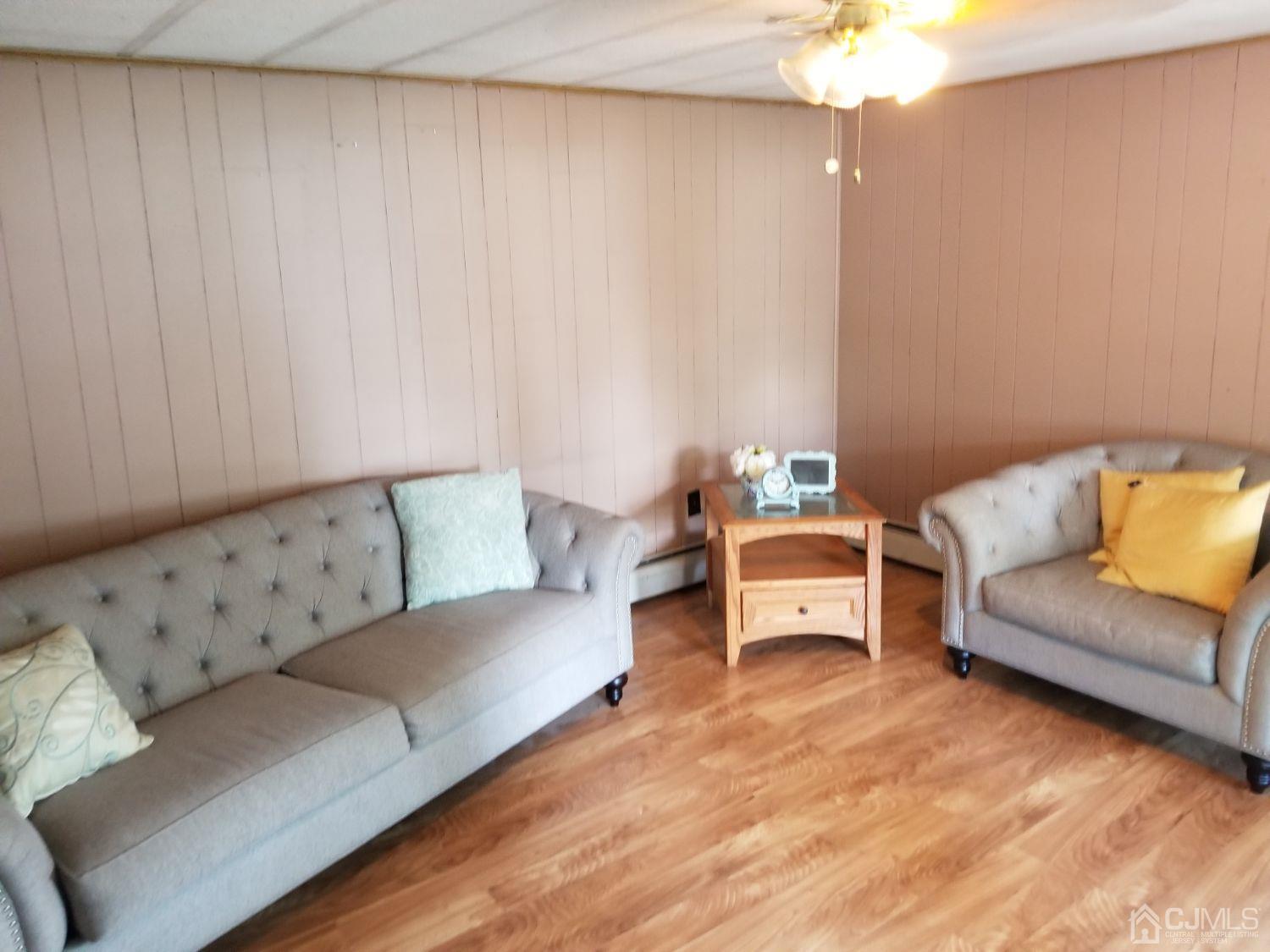 39 Emerson Road North Brunswick, NJ 08902 - Photo 7 of 23 a living room with furniture a couch and a chandelier