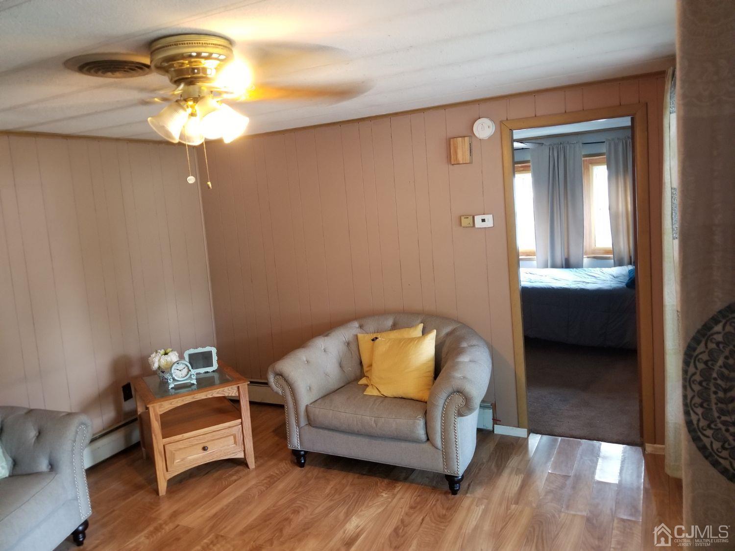 39 Emerson Road North Brunswick, NJ 08902 - Photo 8 of 23 a bedroom with a bed and wooden floor