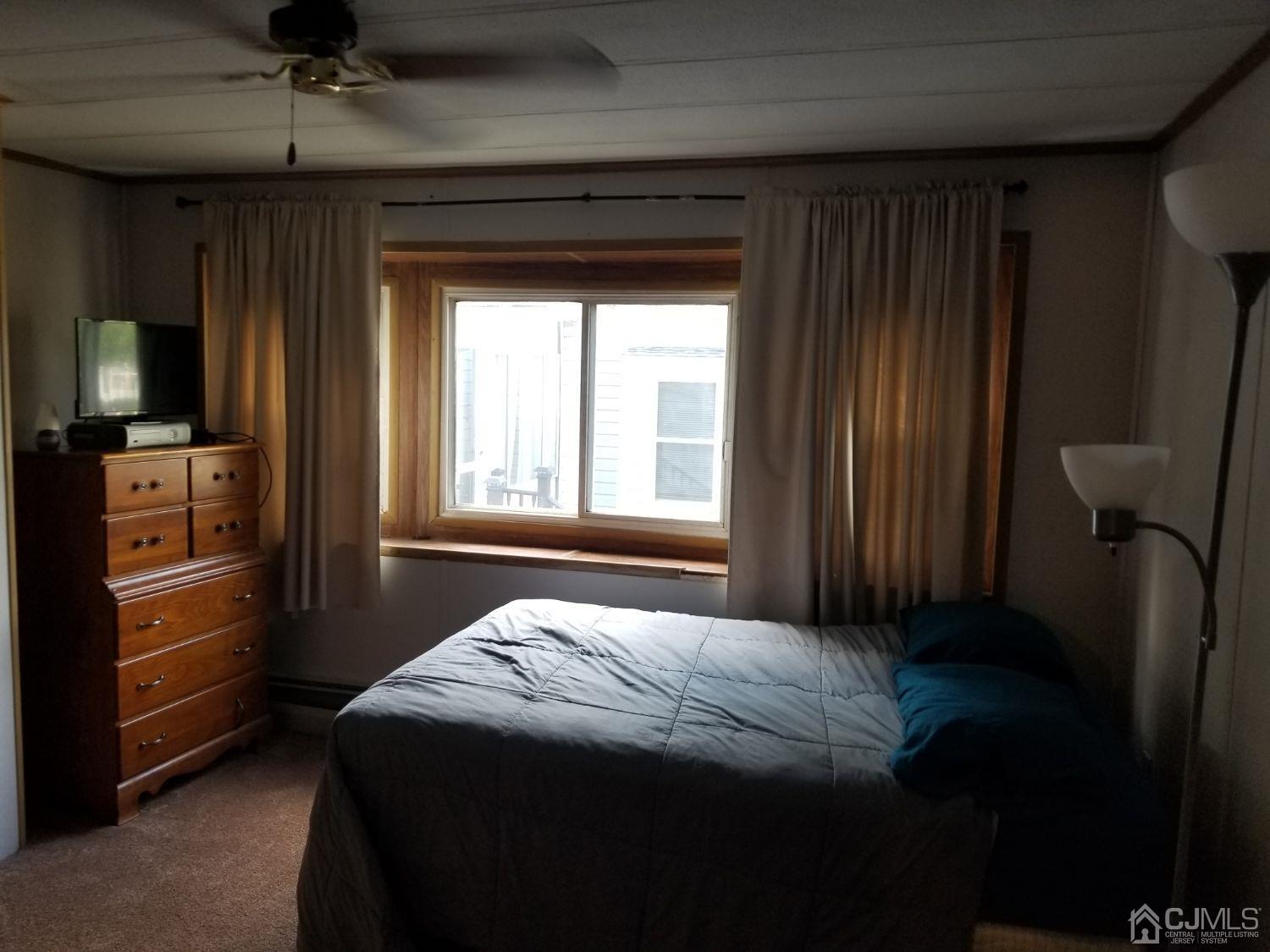 39 Emerson Road North Brunswick, NJ 08902 - Photo 10 of 23 a bedroom with a bed and a television