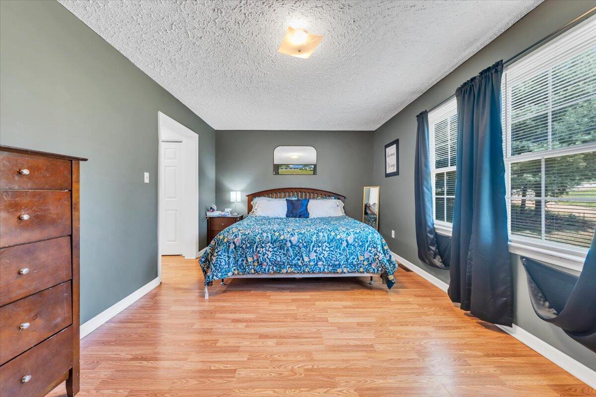 3870 Goose Dam Road Rocky Mount, VA 24151 - Photo 20 of 44 a bedroom with a large bed and wooden floor