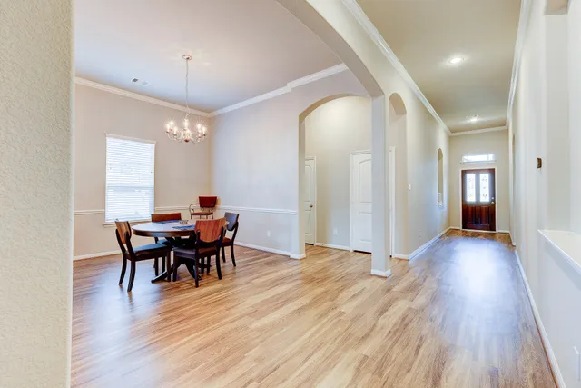 a view of a dining room with furniture and wooden floor