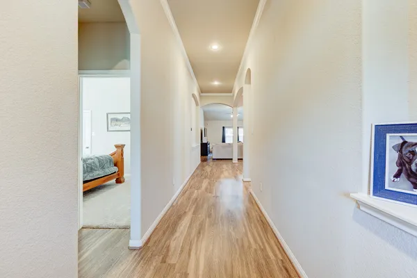 a view of a hallway view with wooden floor and staircase