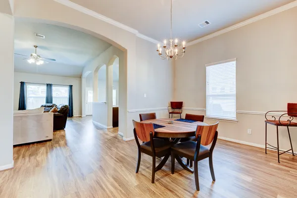a view of a dining room with furniture and wooden floor