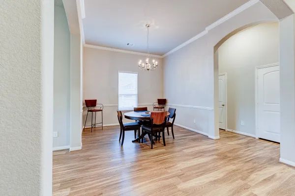a view of a dining room with furniture and wooden floor