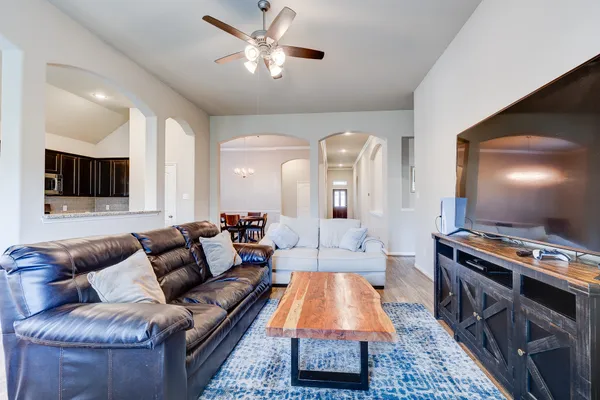 a living room with furniture a flat screen tv and a fireplace