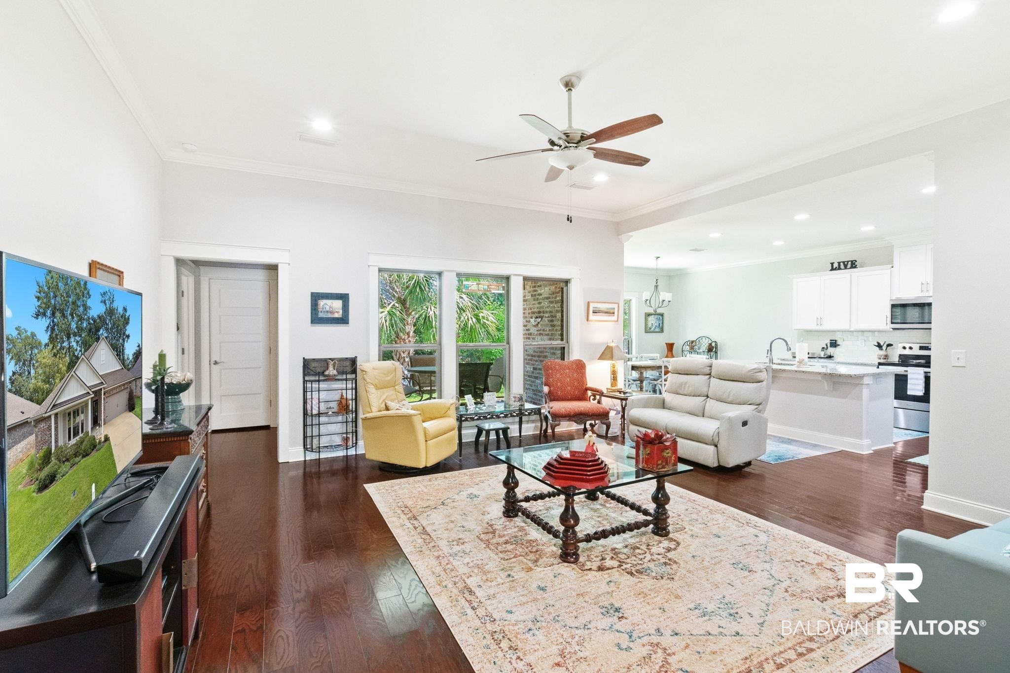 192 Mark Twain Loop Foley, AL 36535 - Photo 10 of 42 Living room with sink, dark hardwood / wood-style flooring, ceiling fan, and crown molding