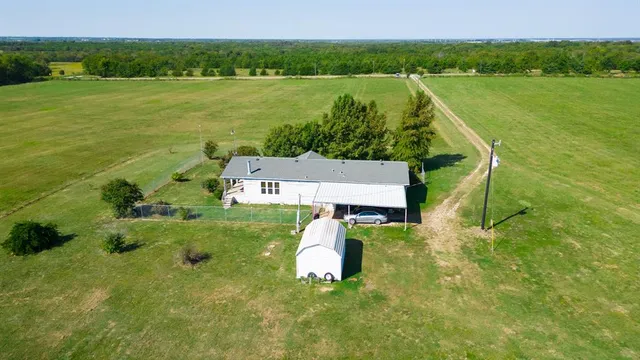 an aerial view of a houses with a lake view