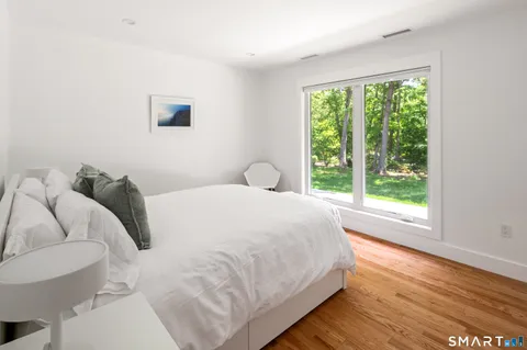 a bedroom with a bed and a large window