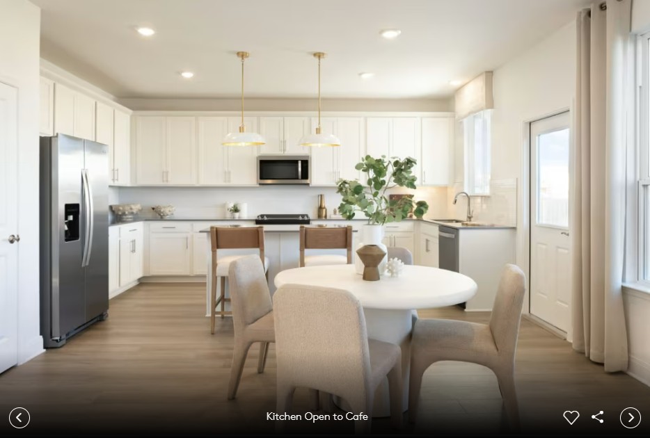 688 Rubber Tree Way Buda, TX 78610 - Photo 7 of 10 a kitchen with kitchen island white cabinets and refrigerator