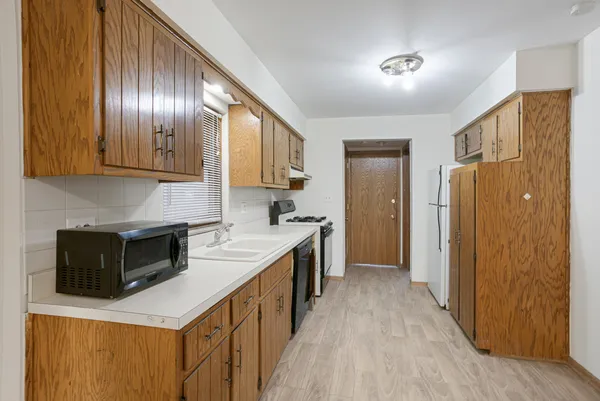 a kitchen with granite countertop stainless steel appliances and wooden cabinets