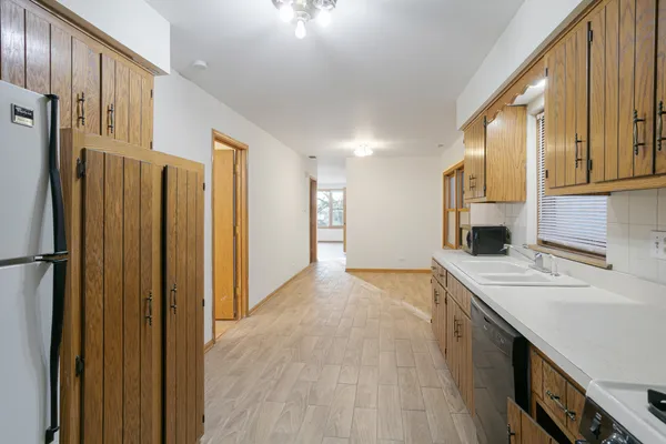 a view of a kitchen with a refrigerator a sink and dishwasher