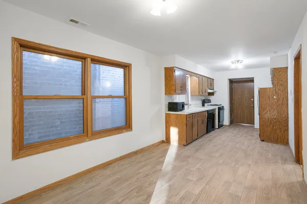 a large kitchen with stainless steel appliances granite countertop a refrigerator and a sink