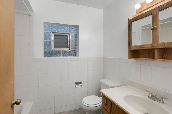 a bathroom with a sink a toilet and mirror