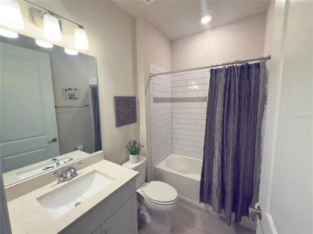 a bathroom with a sink vanity mirror and toilet