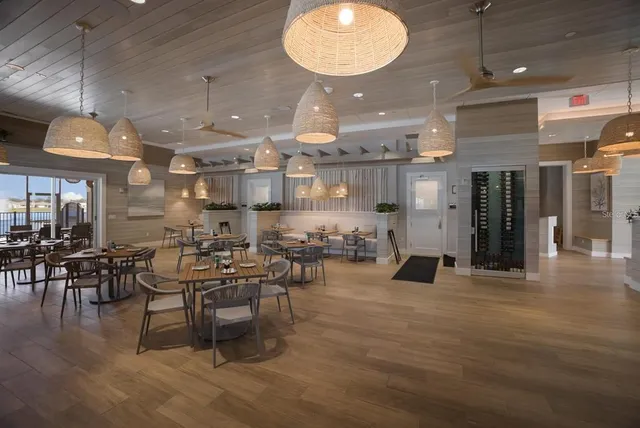 an open kitchen with lots of counter space and chandelier