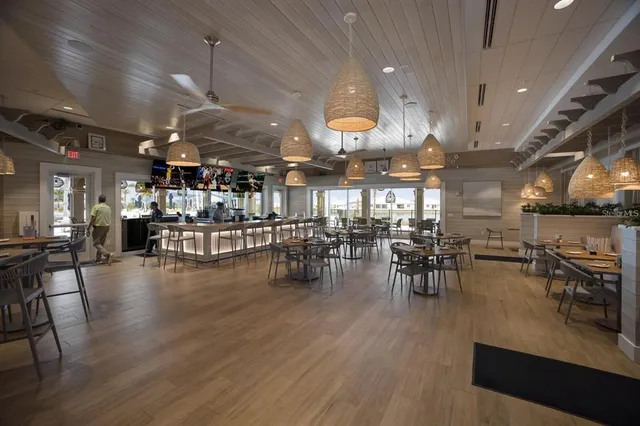 an open kitchen with lots of counter and chairs