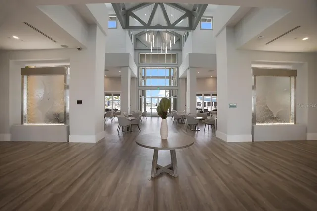 a view of a living room and chandelier with wooden floor