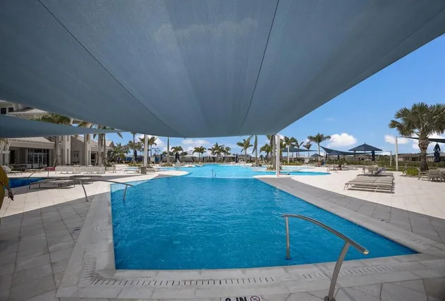 a view of a swimming pool with outdoor seating