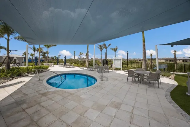 a view of a swimming pool with an outdoor seating