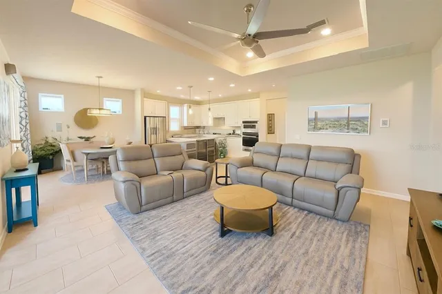 a living room with furniture a rug and a chandelier