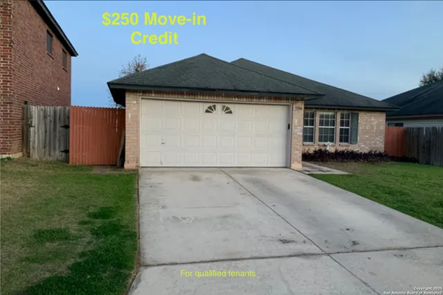 a front view of house with yard and garage