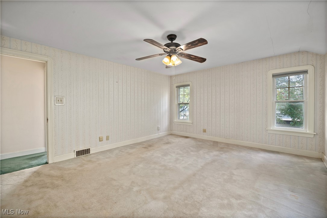 976 Gulf Road Elyria, OH 44035 - Photo 30 of 43 Spare room with light carpet, ceiling fan, and wallpapered walls
