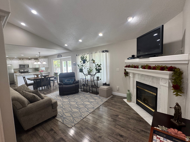 1976 River Bottom Road Springville, UT 84663 - Photo 8 of 45 Open-concept living area featuring wood-finish flooring, a white fireplace with an ornate mantel, and recessed lighting