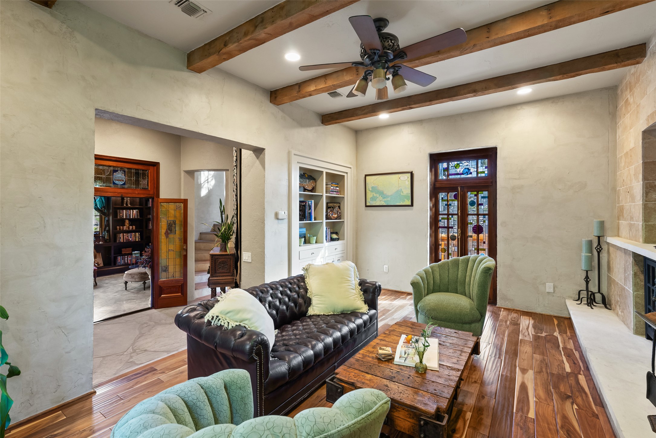 1354 The High Road Austin, TX 78746 - Photo 11 of 40 Exposed beams and rich hardwood floors add character to this inviting living space.