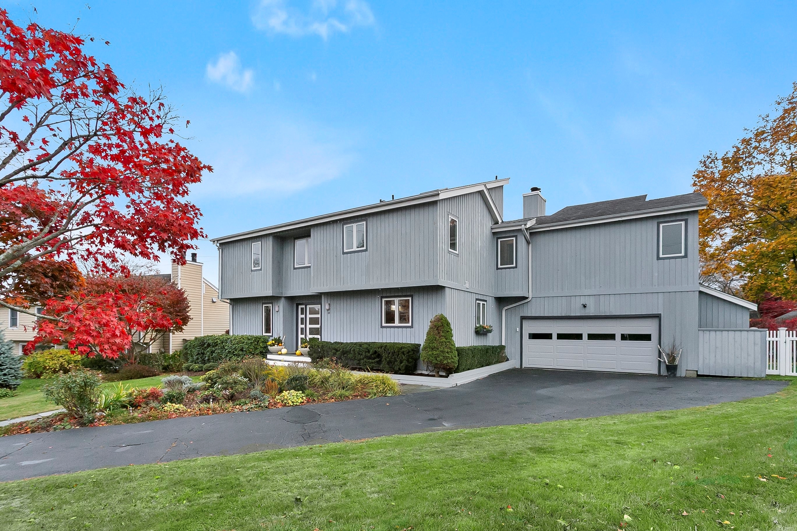 a view of a house with a yard and garden