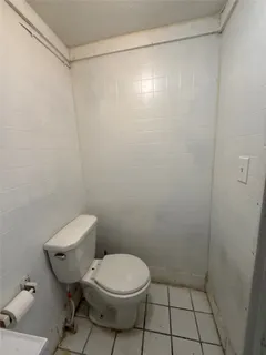 a bathroom with a toilet and a shower curtain