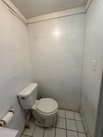 a bathroom with a toilet and a shower curtain