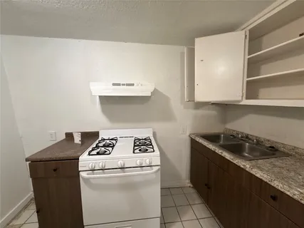 a kitchen with a stove and a cabinets