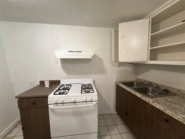 a kitchen with a stove and a cabinets