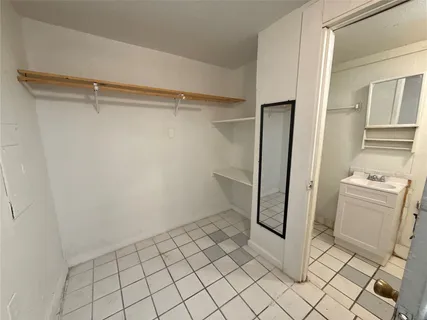 a view of a storage & utility room with a sink
