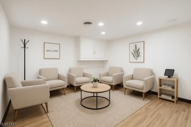 a living room with furniture a rug and a table