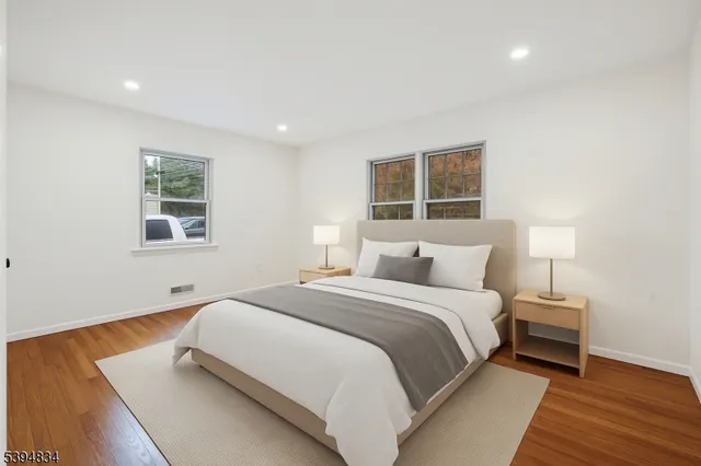 a bedroom with a bed and a night stand