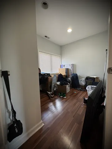 a living room with furniture a wooden floor and a sink
