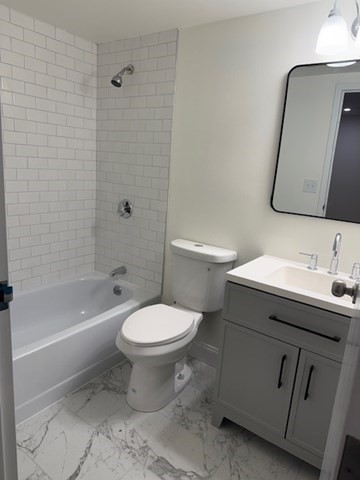 12 Chancery Court, Unit 404 Lynn, MA 01902 - Photo 3 of 10 a bathroom with a sink toilet and shower