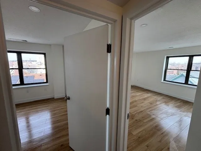 an empty room with windows and closet
