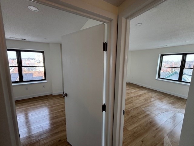 12 Chancery Court, Unit 404 Lynn, MA 01902 - Photo 4 of 10 an empty room with windows and closet