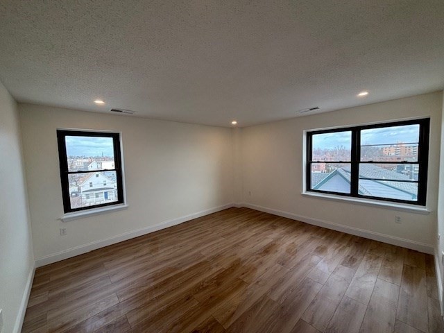 12 Chancery Court, Unit 404 Lynn, MA 01902 - Photo 8 of 10 a view of an empty room with window and wooden floor
