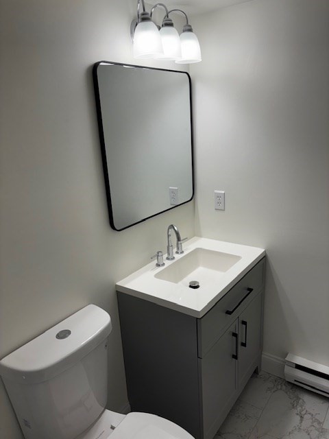 12 Chancery Court, Unit 404 Lynn, MA 01902 - Photo 9 of 10 a bathroom with a toilet sink and mirror