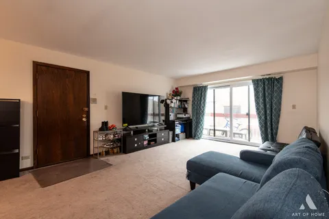 a living room with furniture window and a flat screen tv