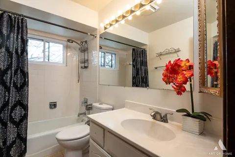 a bathroom with a sink toilet mirror and shower