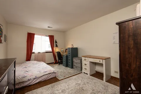 a bedroom with a bed and a television