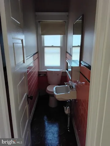 a bathroom with a sink a toilet a mirror and vanity
