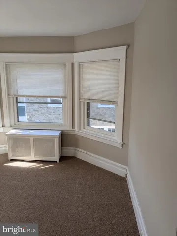 a view of a small space with wooden floor and a window